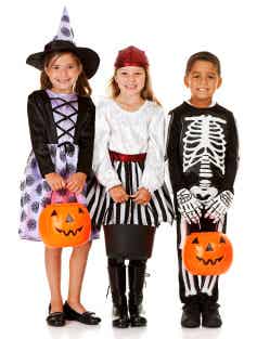 Three children in Halloween costumes