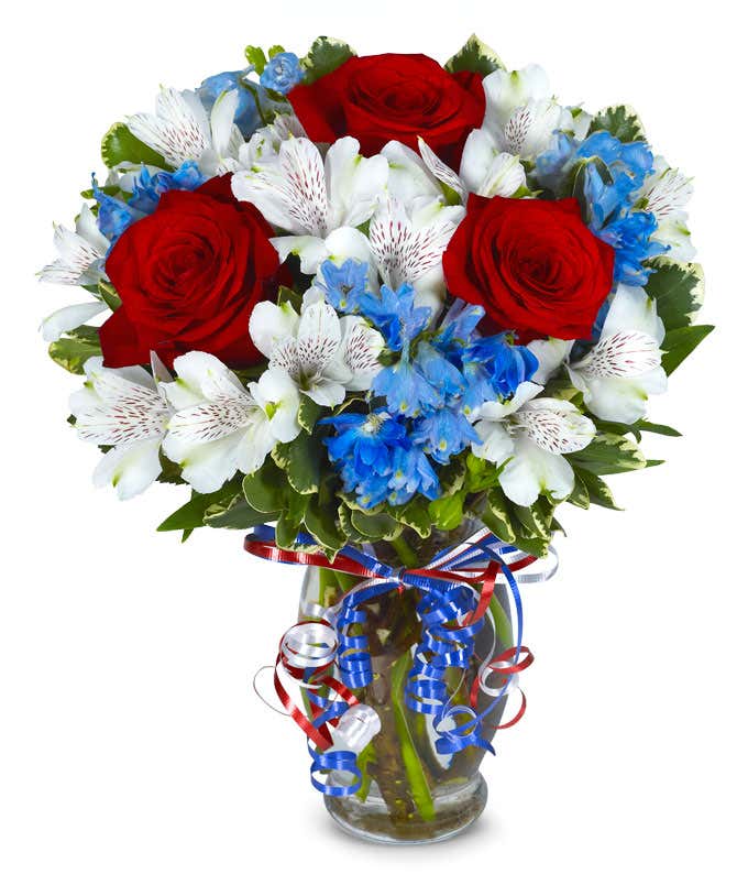 Red roses, white alstroemeria and blue flowers for a patriotic arrangement