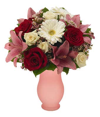 White gerbera daisies, red roses and pink lilies in vase