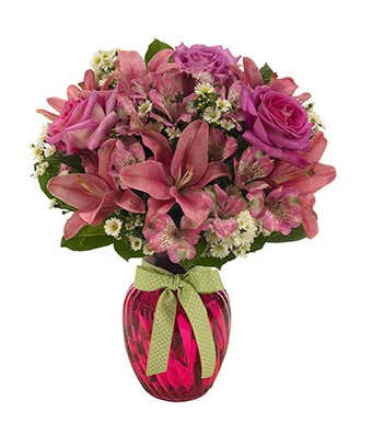 Pink roses, white monte casino and pink asltroemeria in pink vase