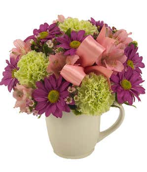 Pink alstroemeria, purple daisies and green poms in a mug
