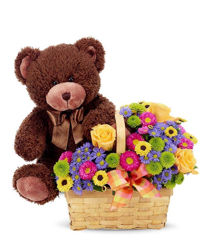 Plush teddy bear delivered inside a basket of flowers