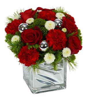 Holiday arrangement with red roses, white poms and red carnations