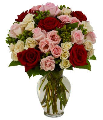 Red roses with pink and white spray roses in a vase