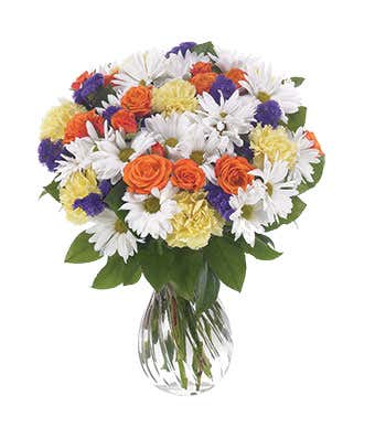White daisies, orange roses and carnations in a vase