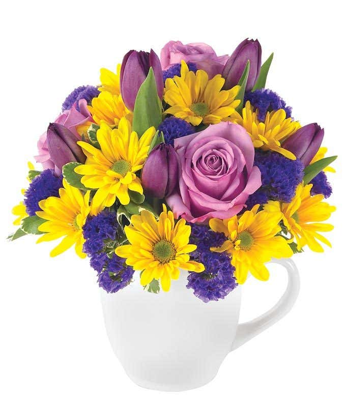 Mug vase with purple roses and tulips