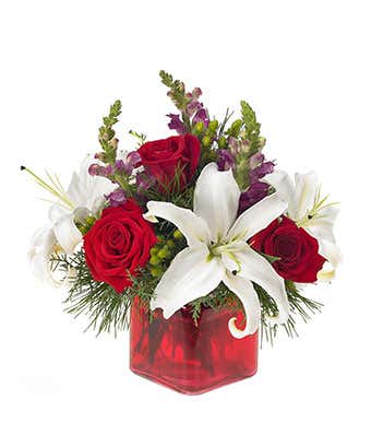 Modern holiday bouquet with roses in a square vase