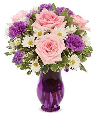 Pink roses, purple carnations and white daisies delivered in a purple vase