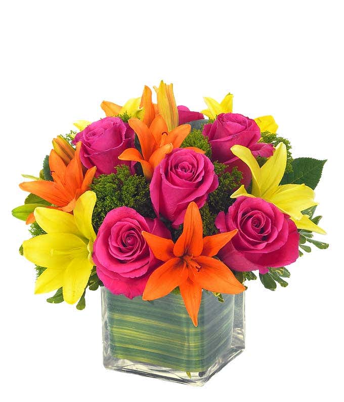 Orange and yellow Asiatic lilies and hot pink roses in square vase