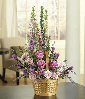Purple and pink roses in a woven basket