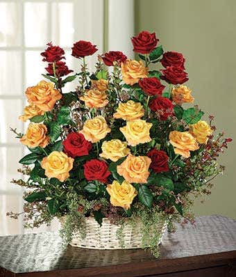 Red roses, orange roses and huckleberry in bouquet