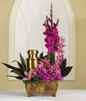 Funeral arrangement of purple dahlias, orchids and gladiolus