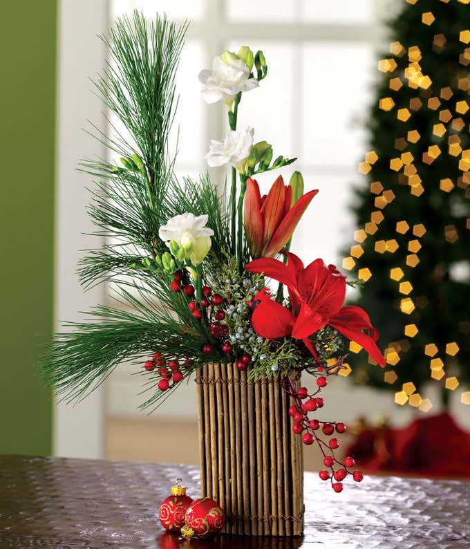 Holiday floral bouquet with lilies, freesia and pine