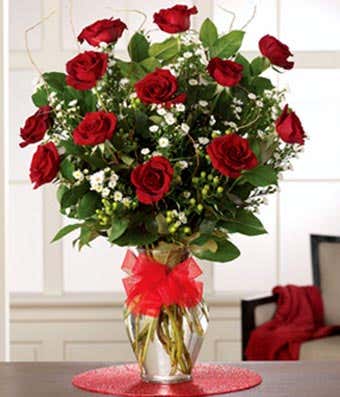 One dozen long stem red roses with hypericum 