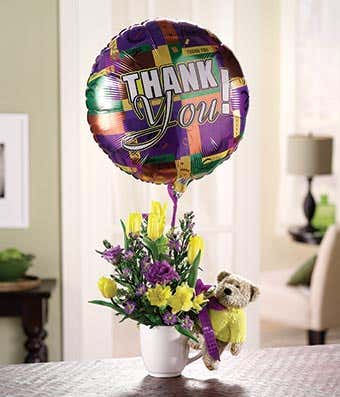 Flowers delivered in a mug with a thank you balloon