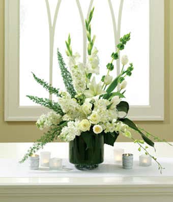 Wedding altar arrangement of white tulips and orchids