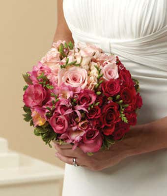 Red roses and hot pink roses in a bridal bouquet for delivery