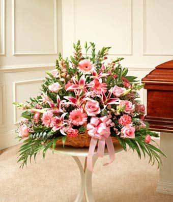 Pink fireside basket with roses, carnations and lilies