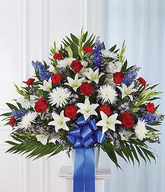 Red roses, white lilies and white mums in a sympathy basket
