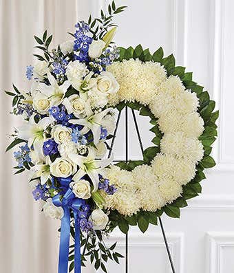 Blue flowers and white flowers standing sympathy wreath