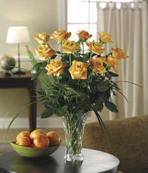 Long stemmed one dozen orange roses in crystal vase