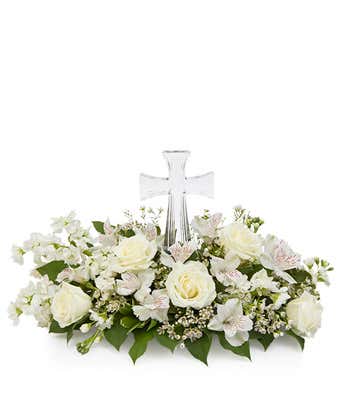 White sympathy flowers with Cross at center