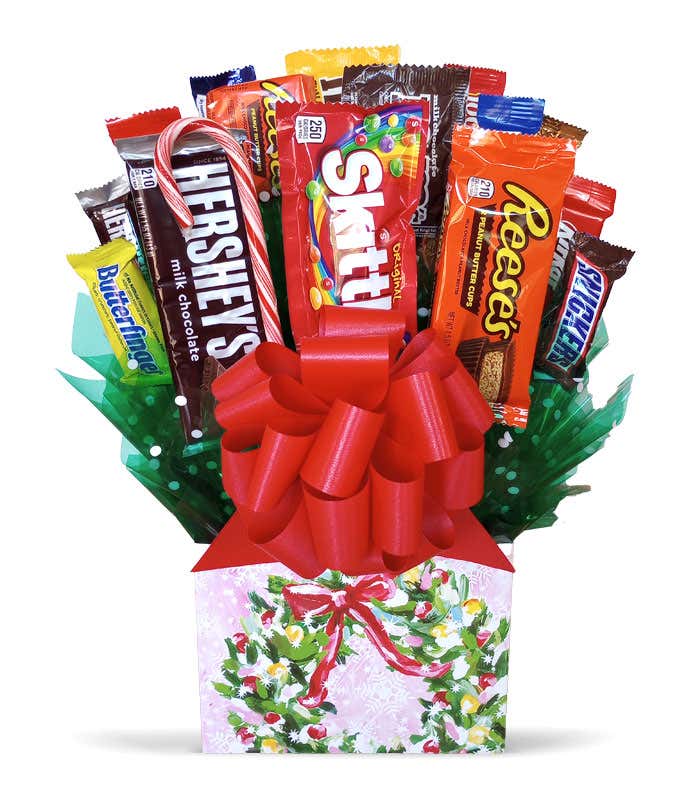 Candy Bouquet with assorted candy bars in a pink gift box with a holiday wreath design, complete with a red bow.