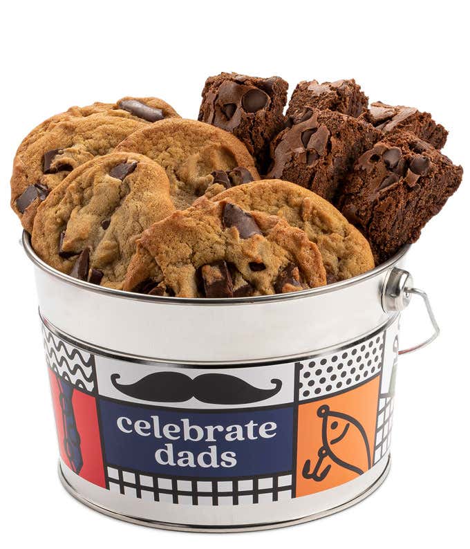 A Celebrate Dads bucket filled with David's cookies and brownies. The bucket features a colorful design with a mustache and a fishing rod. The assortment includes chocolate chip cookies and chocolate brownies.