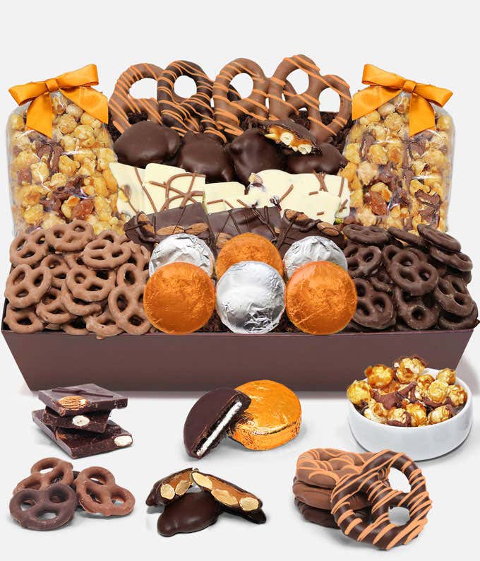 An indulgent assortment featuring 6 OREO cookies covered in Belgian milk chocolate, Belgian milk and dark chocolate covered mini pretzels, large pretzel twists, Belgian chocolate almond and pistachio bark, caramel popcorn, and caramel cashew clusters, in