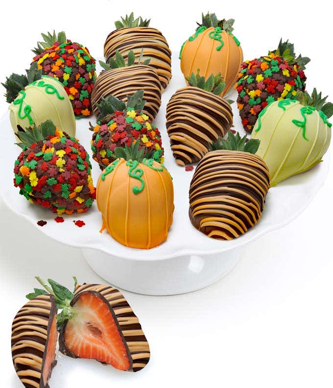 A dozen large strawberries dipped in milk, dark, and white chocolate, adorned with fall-themed sprinkles and chocolate orange drizzle.