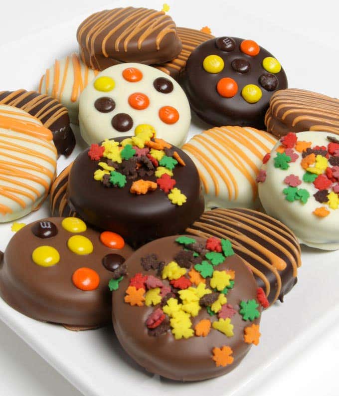 A delectable assortment of 12 chocolate-dipped OREO cookies, coated in white, dark, and milk chocolate, and topped with fall-themed candies.