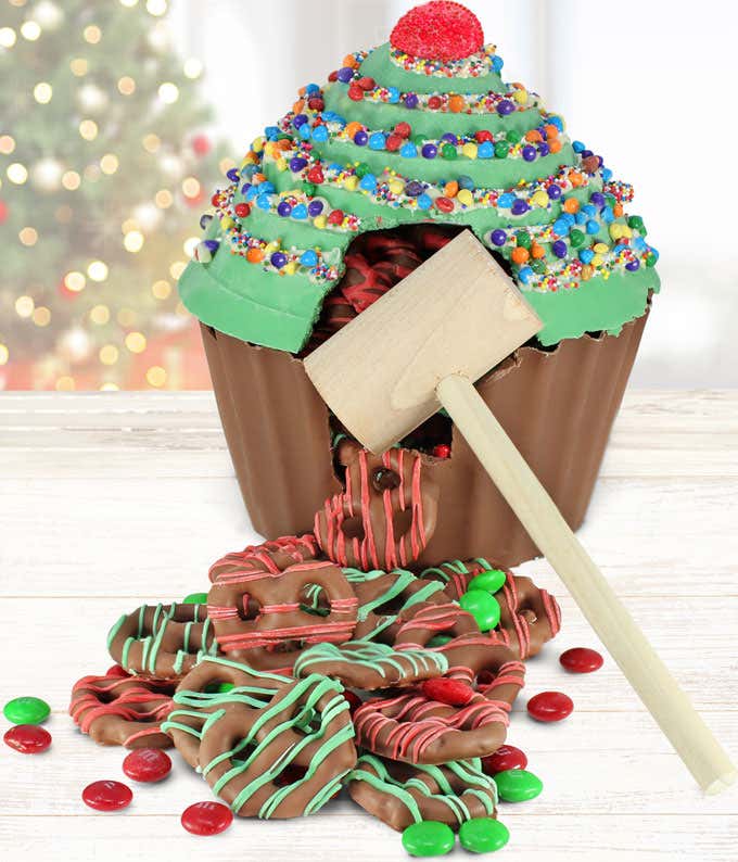 Hollow Belgian chocolate cupcake decorated like a Christmas tree, filled with M&M's and chocolate covered pretzels