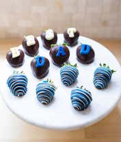 Alternative image 1 for A delightful Father's Day gift featuring one dozen fresh strawberries, dipped in Belgian chocolate and adorned with blue swizzle decorations. This indulgent treat offers a perfect blend of sweetness and elegance to celebrate Dad's special day.