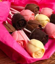 Alternative image 3 for A bouquet of Belgian chocolate roses in milk, dark, and white chocolate, wrapped in pink tissue paper and tied with a cream ribbon, accompanied by a bottle of red wine and card reading 