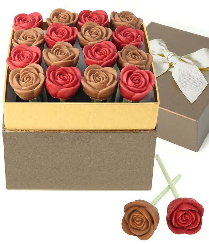 Valentine’s Day chocolate rose gift box featuring red and milk chocolate rose-shaped candies arranged in a gold-trimmed box, with a ribboned gift lid and two chocolate rose pops displayed in front.