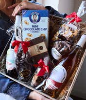 Alternative image 1 for A gift set featuring a bottle of California Sparkling Wine paired with chocolate-covered pretzels, mini cookies, caramel popcorn, chocolate peanut butter buckeyes, 6 chocolate-covered Oreos, a box of assorted chocolates, and I Love You card.