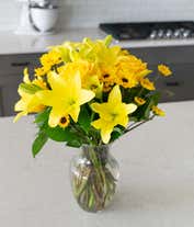 Alternative image 1 for A bouquet featuring yellow lilies, yellow roses, and yellow poms, with an optional glass vase.