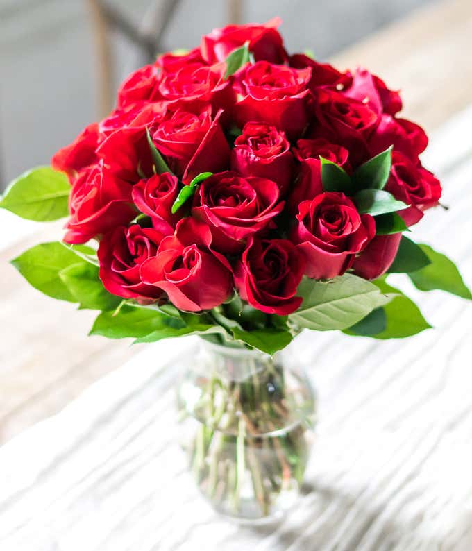 Two Dozen Red Roses in a Clear Glass Vase 