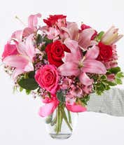 Alternative image 4 for A beautiful arrangement featuring pink Asiatic lilies, pink and red roses, and alstroemeria, optionally arranged in a glass vase. This elegant mix offers a lovely and vibrant display