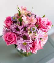 Alternative image 1 for A bouquet featuring pink roses, purple daisies, pink alstroemeria, purple alstroemeria, and purple Monte Casino, with an optional vase.