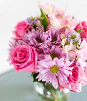 Alternative image 2 for A bouquet featuring pink roses, purple daisies, pink alstroemeria, purple alstroemeria, and purple Monte Casino, with an optional vase.