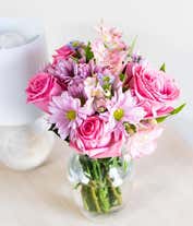 Alternative image 3 for A bouquet featuring pink roses, purple daisies, pink alstroemeria, purple alstroemeria, and purple Monte Casino, with an optional vase.