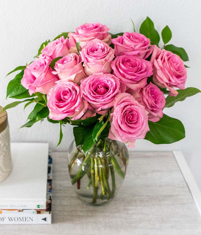 One Dozen Light Pink Long Stem Roses in a Clear Glass Vase