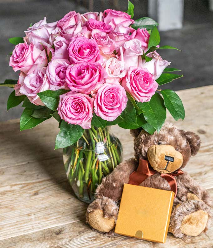 Two Dozen Pink Roses with a Clear Glass Vase, Chocolates, & Teddy Bear