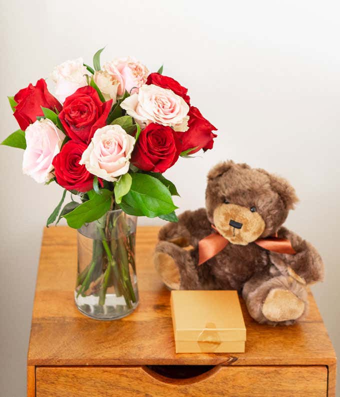 One Dozen Red & Pink Roses with a Clear Glass Vase, Chocolates, & Teddy Bear
