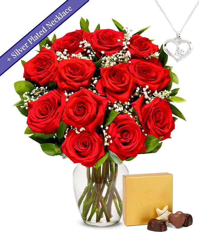 One dozen red roses with a silver heart necklace on a chain and a small box of assorted chocolates