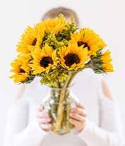 Alternative image 2 for A vibrant arrangement featuring yellow sunflowers and golden solidago, optionally presented in a vase. This bright and cheerful display brings a touch of sunshine and warmth to any occasion. 