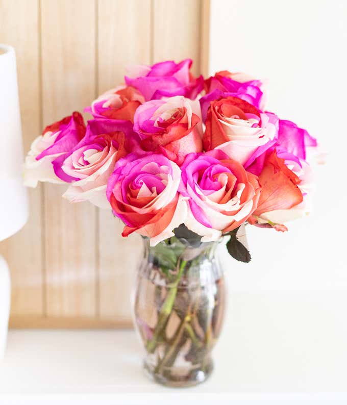 One Dozen Wild Pink Roses in Clear Glass Vase