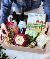 Alternative image 2 for An abundant gift box filled with two bottles of California wine - red & white, assorted crackers, three cheeses, summer sausage, and snacks to make an amazing charcuterie spread. 