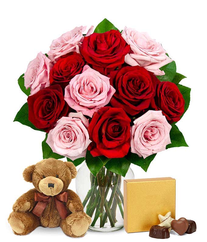 Pink and red roses with chocolates and a bear